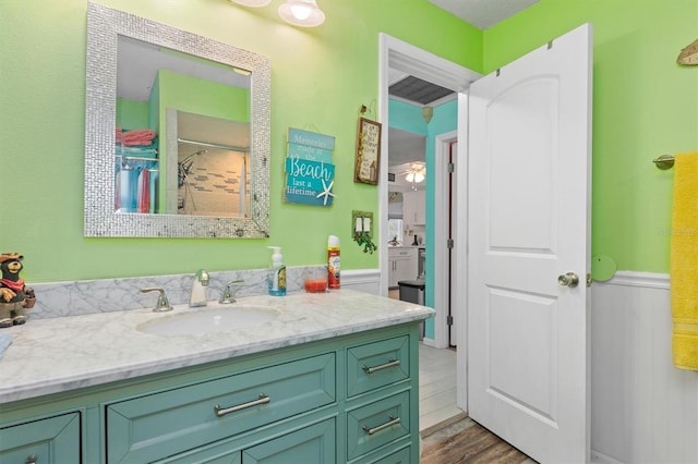 bathroom featuring walk in shower, vanity, and hardwood / wood-style flooring