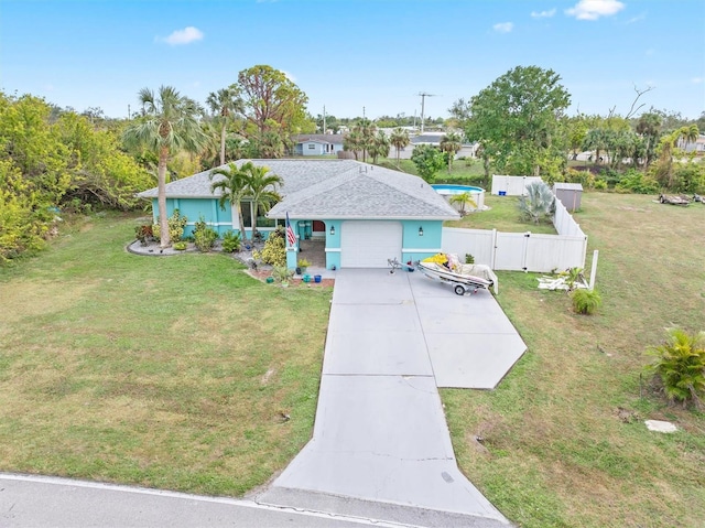 view of front of house with a front lawn and a garage