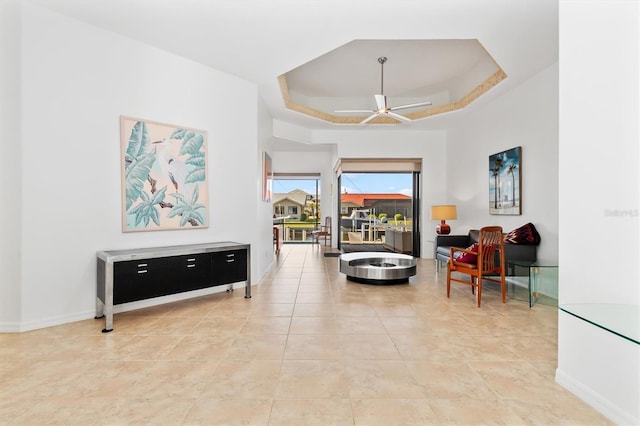 interior space featuring ceiling fan and a tray ceiling