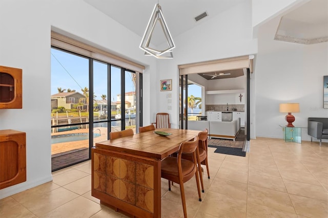 dining room featuring sink and light tile patterned flooring