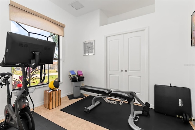 exercise room featuring light tile patterned flooring