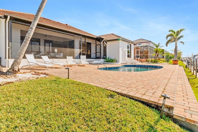 view of pool with a lanai, a yard, and a patio