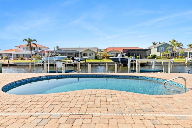 view of pool with a water view and a dock