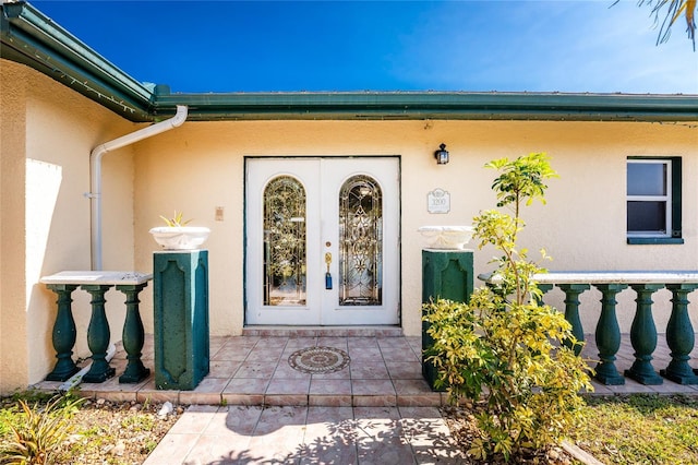 view of exterior entry featuring french doors