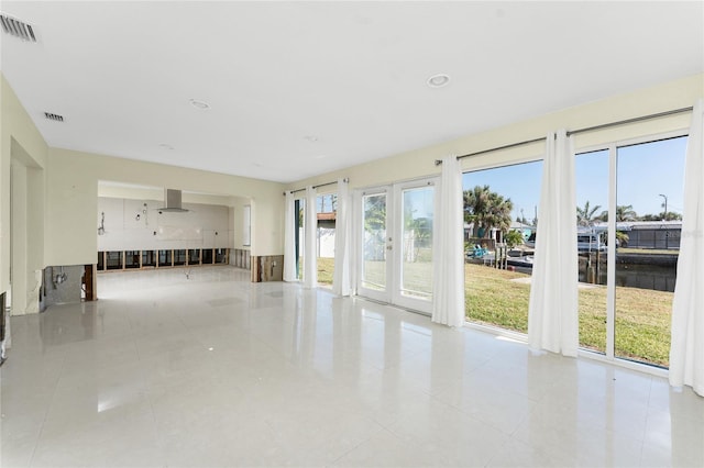 unfurnished living room with light tile patterned floors