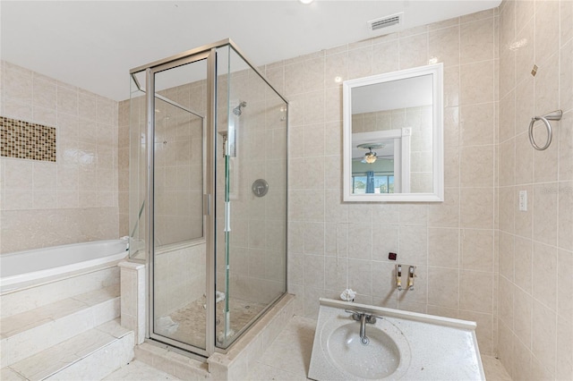 bathroom featuring tile walls, tile patterned floors, and plus walk in shower