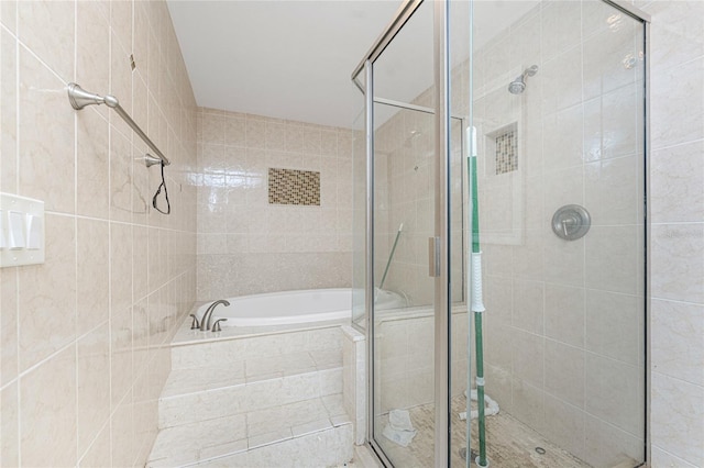 bathroom with separate shower and tub