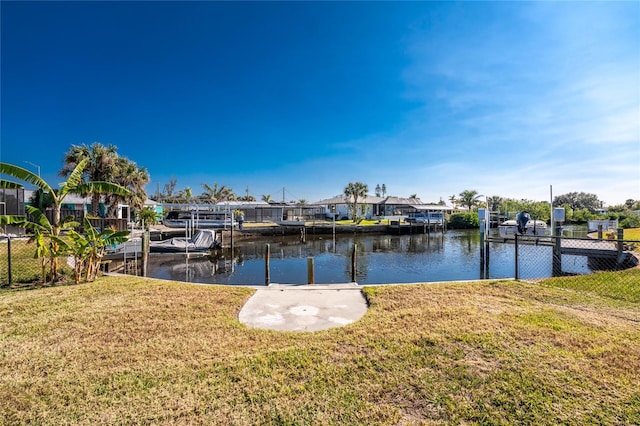 view of dock featuring a yard and a water view