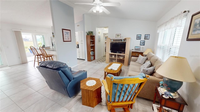 living room with lofted ceiling, light tile patterned floors, and ceiling fan