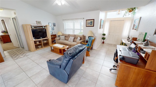 tiled living room featuring lofted ceiling and ceiling fan