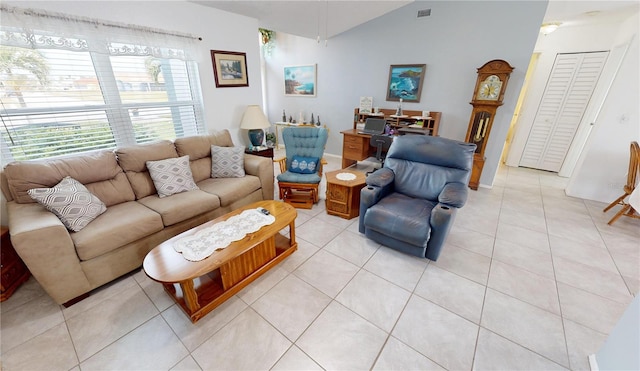 living room featuring light tile patterned flooring and lofted ceiling