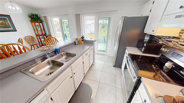 kitchen with pendant lighting, white cabinetry, backsplash, light tile patterned flooring, and stainless steel electric stove