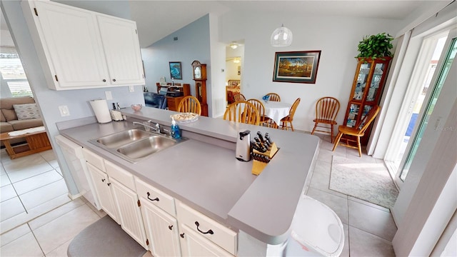 kitchen featuring sink, pendant lighting, white cabinets, and light tile patterned floors