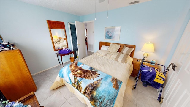 tiled bedroom featuring a textured ceiling