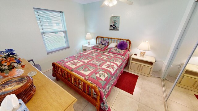 bedroom with ceiling fan and light tile patterned flooring