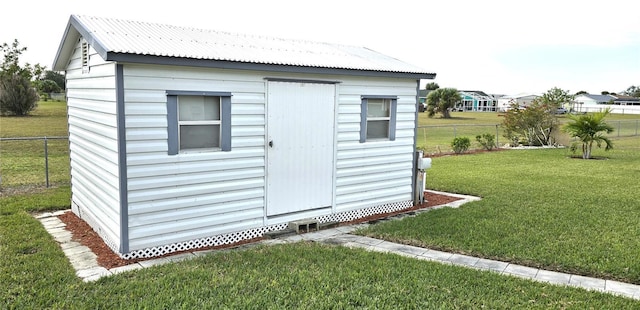 view of outbuilding featuring a yard