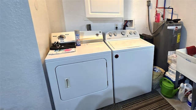 clothes washing area with cabinets, separate washer and dryer, and electric water heater