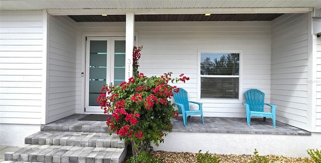 view of exterior entry with a porch