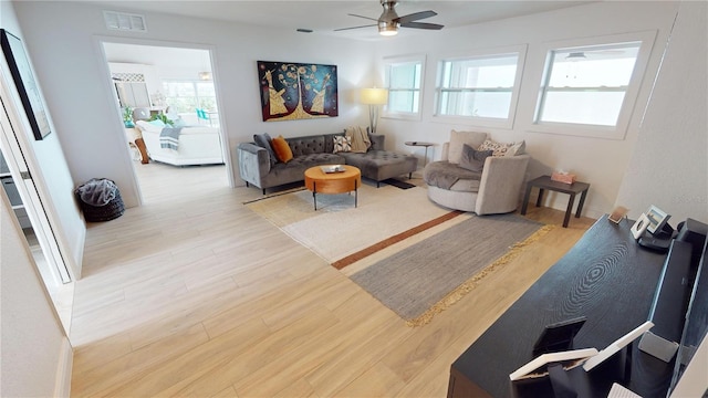 living room with light wood-type flooring and ceiling fan