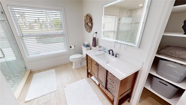 bathroom featuring plenty of natural light, an enclosed shower, and vanity