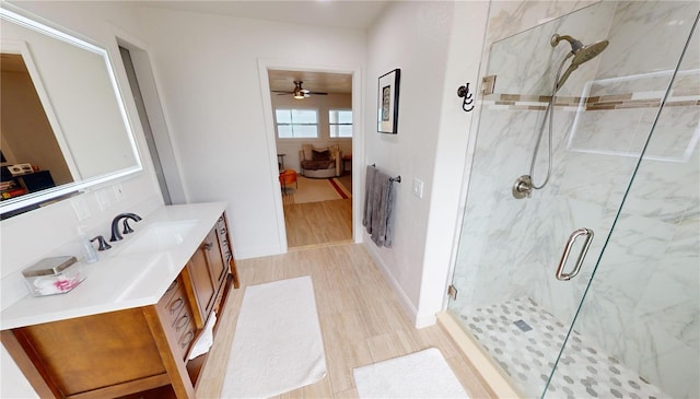 bathroom featuring an enclosed shower, vanity, ceiling fan, and wood-type flooring