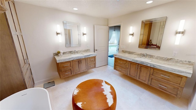 bathroom featuring vanity and a tub