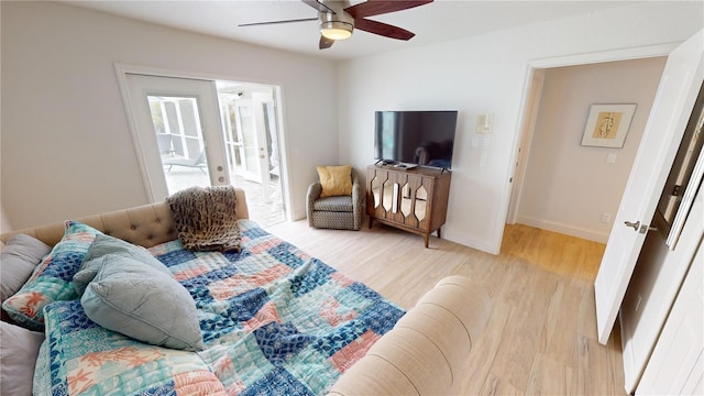 living room featuring ceiling fan and light hardwood / wood-style flooring