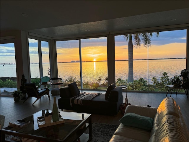 sunroom featuring a water view