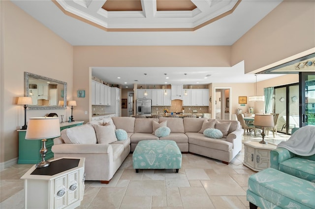 living room with a towering ceiling, beam ceiling, crown molding, and coffered ceiling