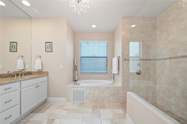 bathroom with a chandelier, independent shower and bath, and vanity