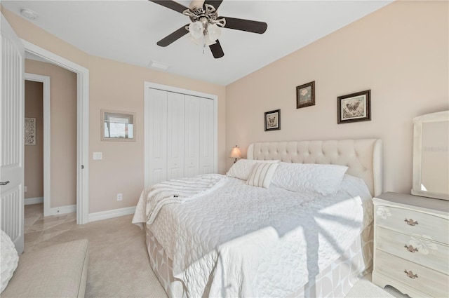 carpeted bedroom featuring a closet and ceiling fan