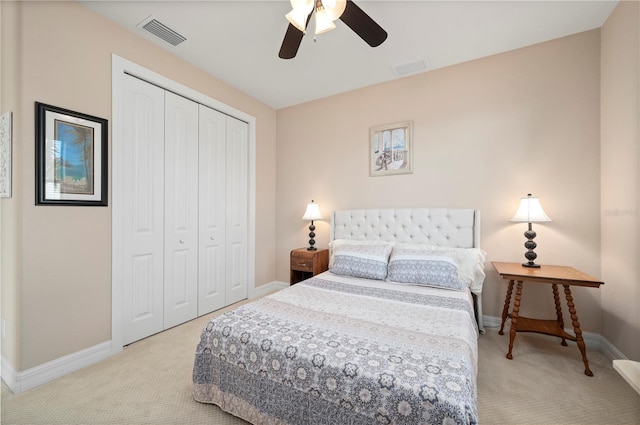 bedroom with ceiling fan, a closet, and light carpet