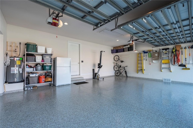 garage with a garage door opener, water heater, and white fridge