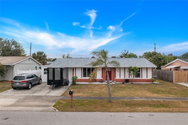 single story home featuring a front lawn