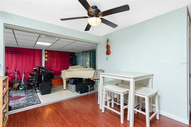 bedroom featuring wood-type flooring, ceiling fan, and a paneled ceiling