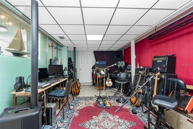 miscellaneous room with tile patterned floors and a drop ceiling