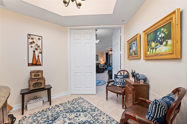 corridor featuring visible vents, baseboards, and light tile patterned flooring