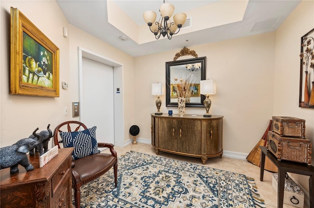 interior space featuring a chandelier, a tray ceiling, light tile patterned floors, and baseboards