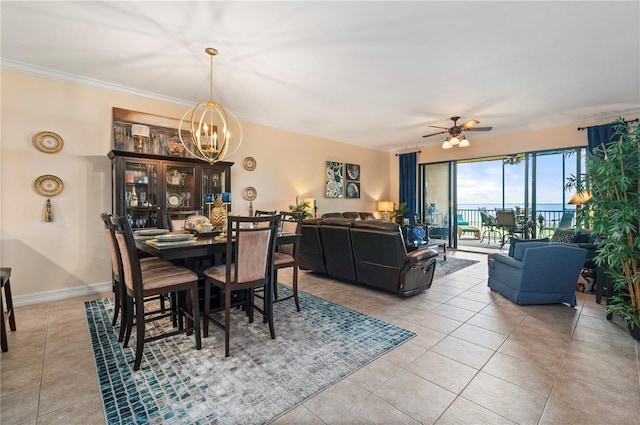 dining space with light tile patterned floors, baseboards, crown molding, and ceiling fan with notable chandelier