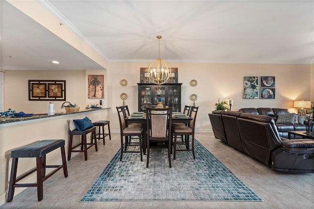 dining space with ornamental molding, a chandelier, light tile patterned flooring, and baseboards