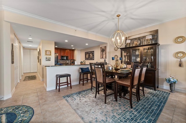 dining space featuring ornamental molding, a chandelier, and light tile patterned flooring