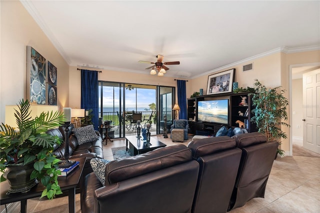 living area featuring light tile patterned floors, ceiling fan, visible vents, and ornamental molding