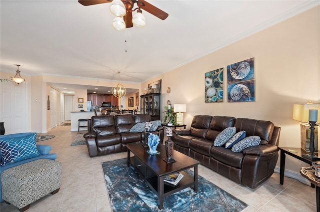 living area featuring ornamental molding, baseboards, and light tile patterned floors