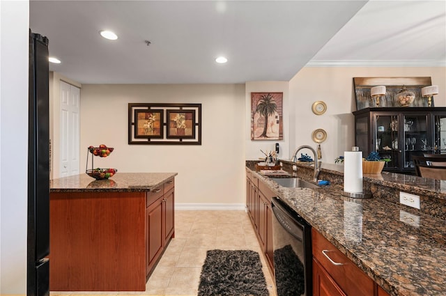 kitchen with light tile patterned floors, baseboards, dark stone counters, black appliances, and a sink