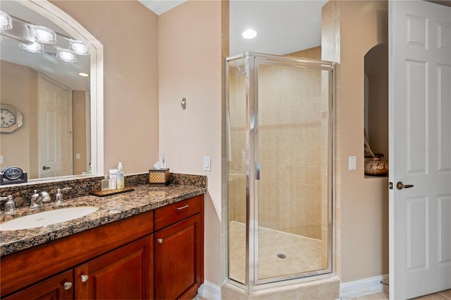 full bath with a shower stall and vanity