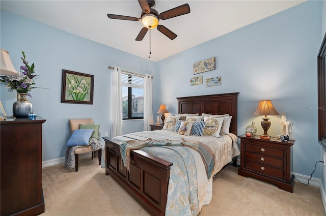 bedroom featuring light carpet, a ceiling fan, and baseboards