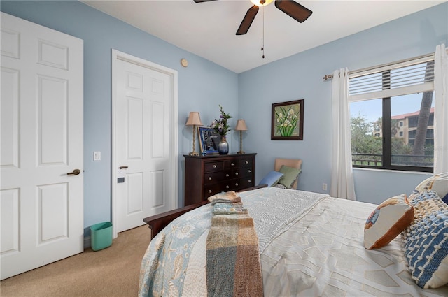 bedroom featuring light carpet and ceiling fan