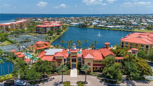 drone / aerial view with a water view and a residential view