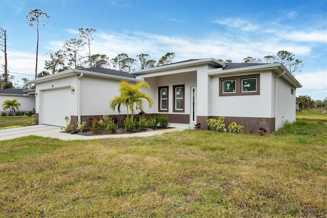 view of front of property with a garage and a front lawn