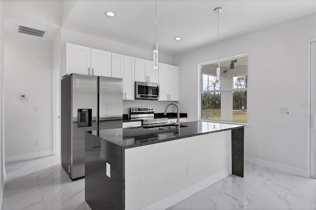 kitchen with sink, white cabinetry, an island with sink, pendant lighting, and stainless steel appliances